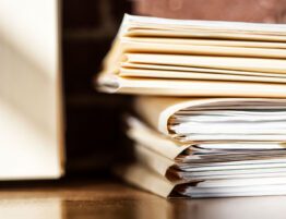 Stack of legal and financial documents representing complex asset analysis in high-asset divorce cases
