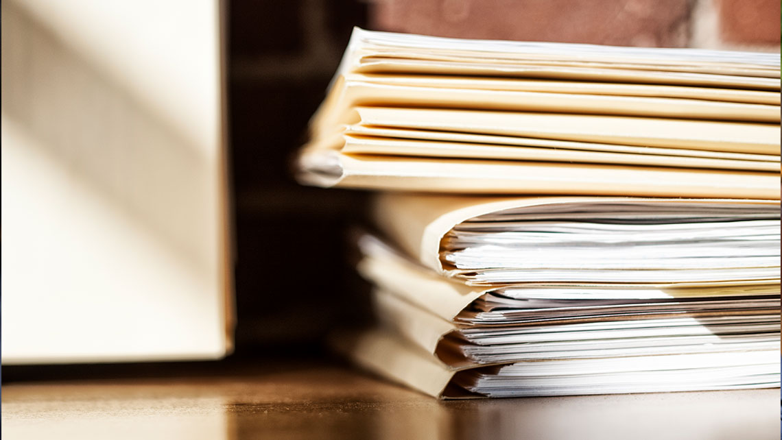 Stack of legal and financial documents representing complex asset analysis in high-asset divorce cases