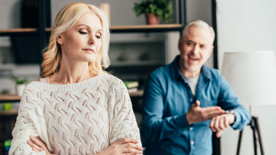 Couple experiencing different feelings about divorce settlement during financial discussion