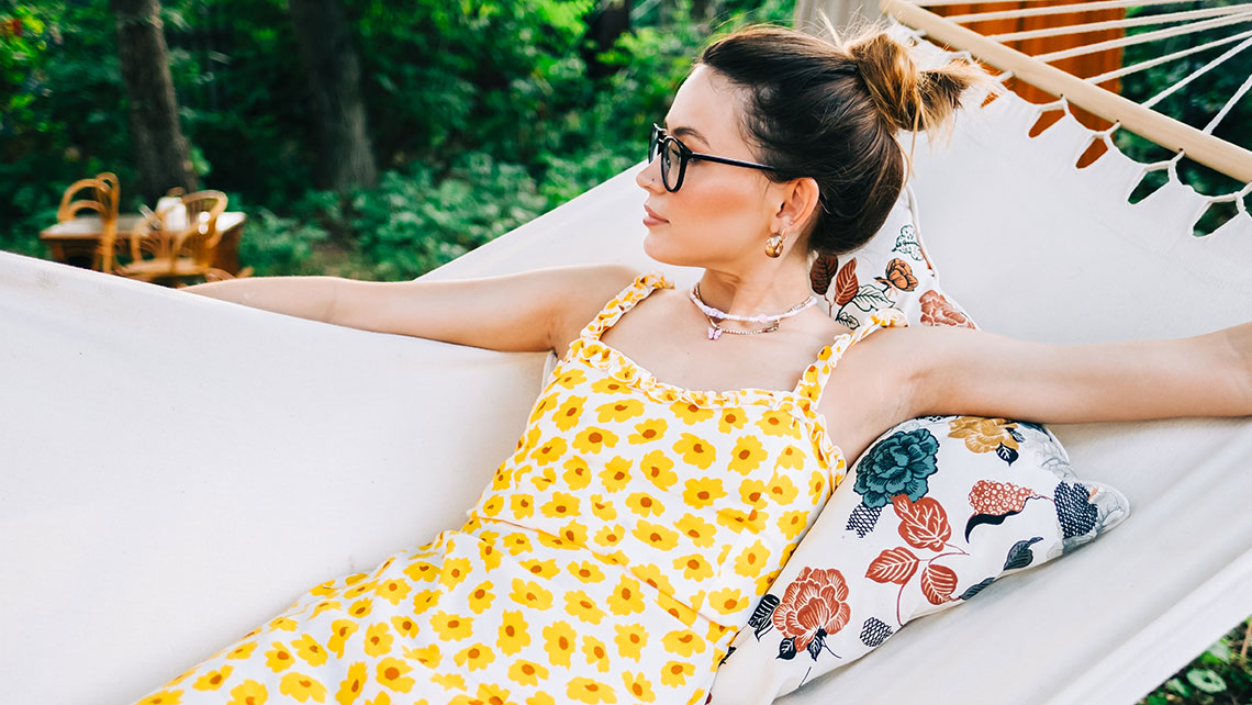 Woman relaxing in a hammock while reflecting on financial planning and divorce strategy during the summer months