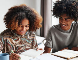 Two children studying together, representing the long-term financial planning involved in child related expenses after divorce.
