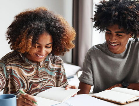 Two children studying together, representing the long-term financial planning involved in child related expenses after divorce.