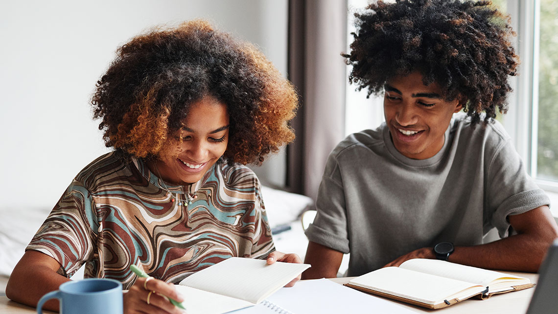 Two children studying together, representing the long-term financial planning involved in child related expenses after divorce.