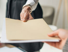 Financial documents being exchanged during divorce, representing the importance of financial documentation during divorce.