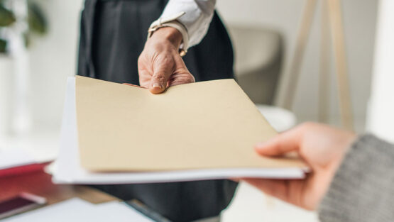 Financial documents being exchanged during divorce, representing the importance of financial documentation during divorce.